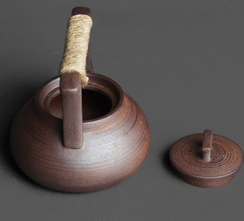 A close-up of a handcrafted Japanese teapot, placed centrally on an old  wooden table. There are steam tendrils rising from the spout, suggesting a  freshly made hot brew. 28781861 Stock Photo at